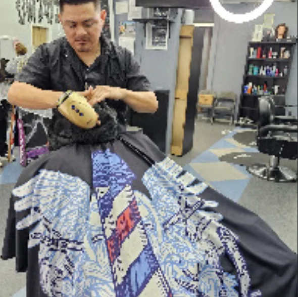 Barber working on a design cut