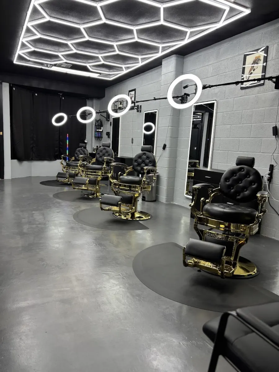 Row of gold and black barber chairs