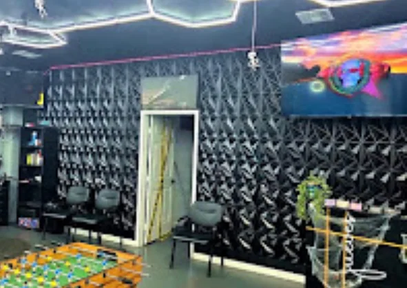Shop floor with textured black wall and foosball table